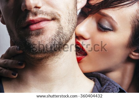 Woman kissing a man on the neck