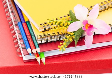 Notebook with pencil and flower orchid