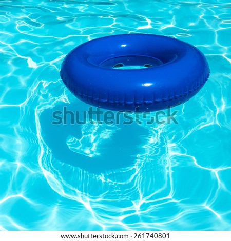 Blue inner tube on water pool