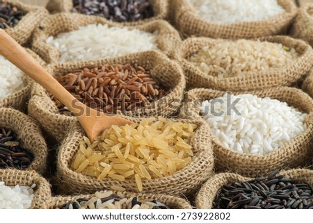 Close-up brown rice with wooden spoon in burlap bag