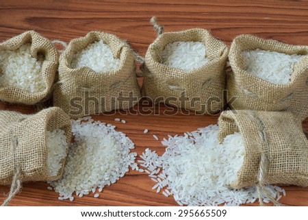 Jasmine rice and japan rice with burlap bag on the plank