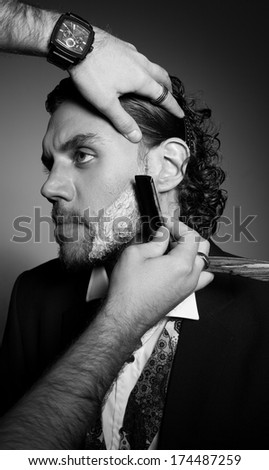 An image of a handsome man with a beard and stylish hairstyle
