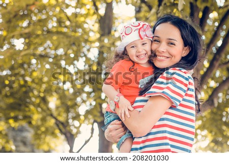 Portrait of laughing young beautiful mother and daughter
