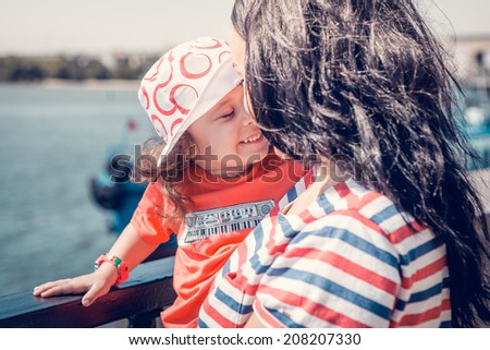 Emotionally positive sensual portrait of a beautiful mother and little daughter