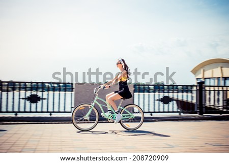 stylish girl hipster riding a  cruiser bicycle