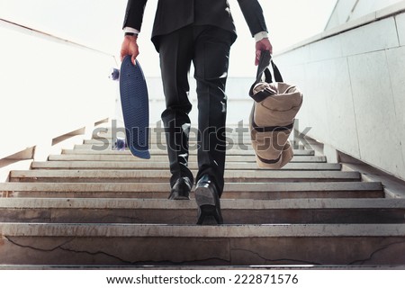Close-up of Stylish successful businessman goes up the stairs