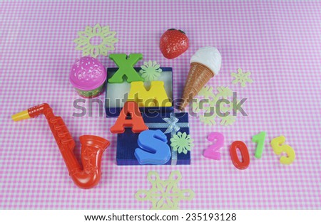 Christmas 2015 decoration with colorful toys on pink background