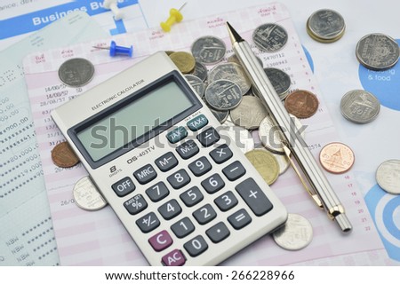 Calculator, pen, pin and coin on saving book, accounting background