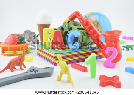 Colorful plastic toys on white background, children education concept