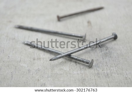 Old rust metal nails on wood board, rustic style