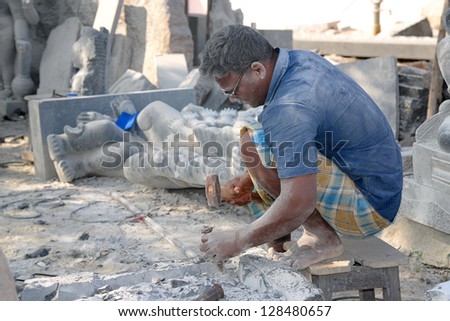 MAMMALAPURAM, INDIA - JAN 25:An artisan, inhaling unhealthy stone dust causing serious lung disease pneumoconiosis while making statues of Gods and Goddesses on January 25, 2013 in Mammalapuram, India