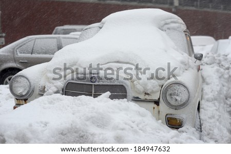 NEW YORK, USA - FEB 16:A sixties Mercedes Benz luxury car buried under layers of snow during severe snow storm on February 16, 2014 in New York, USA