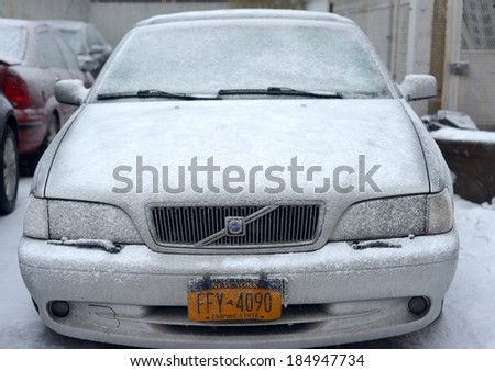 NEW YORK, USA - FEB 16:A Volvo luxury car buried under layers of snow during severe snow storm on February 16, 2014 in New York, USA