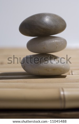 zen stones on bamboo background meditation concept