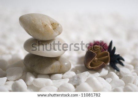 zen stones on white pebbles background - meditation concept