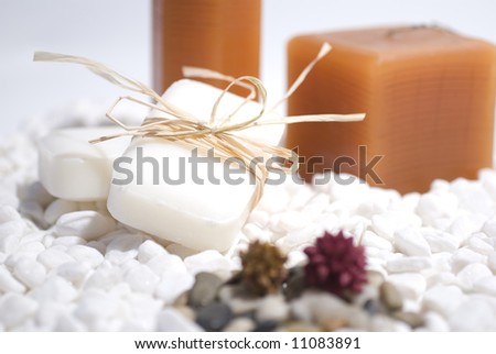 SPA zen candles and soap on white pebbles background,  meditation concept