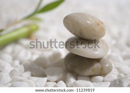 zen stones and bamboo on white pebbles background - meditation concept