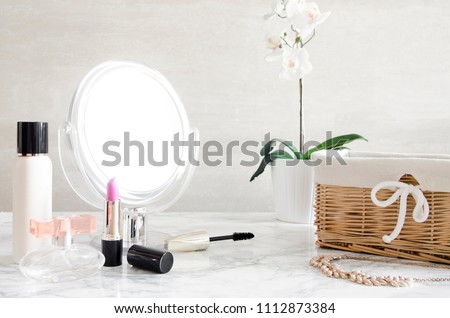 cosmetics and a mirror on the dressing table in the bathroom
