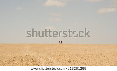 NEGEV DESERT, ISRAEL - APRIL: Two hikers from Europe walking in Negev Desert on April, 2013 in Negev Desert, Israel.