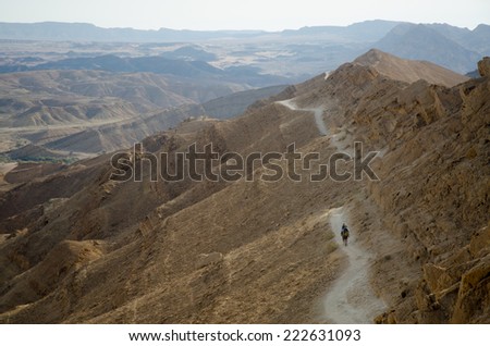 NEGEV DESERT, ISRAEL - CIRCA APRIL,2013 -  Two hikers from Europe walking in Negev Desert using Israel National Trail.    D. The Israel National Trail, is a hiking path that was inaugurated in 1995.