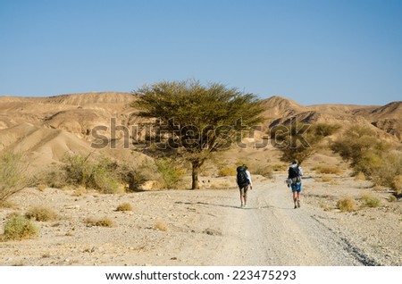 NEGEV DESERT, ISRAEL - CIRCA APRIL,2013 - Two hikers from Europe walking in Negev Desert on Israel National Trail.