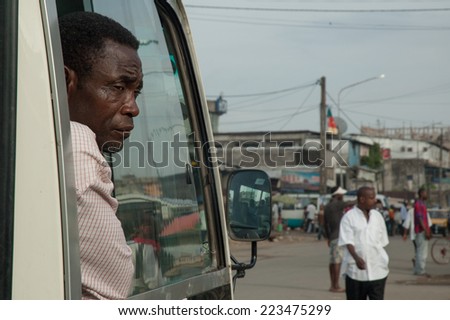 DOUALA,CAMEROON - CIRCA MAY 2008 -  Unidentified man looks through the window of the bus.