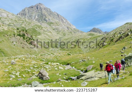 PYRENEES, SPAIN - CIRCA JULY, 2012 - Group of people walking in the Spanish Pyrenees (GR11 trail) near Mt. Vignemale 3298m