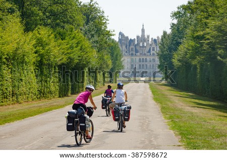 Chambord , France - CIRCA August, 2015  - Bikers bicycle touring with pannier near Chambord Castle in France, Loire Valley