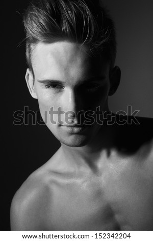 Closeup portrait of sensual man with beautiful face and eyes in black and white
