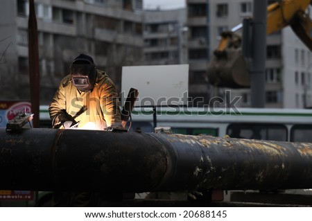 construction worker welding pipe