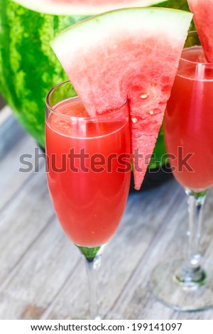 Watermelon Bellini Cocktail in Champagne glass with watermelon chunk on the glass