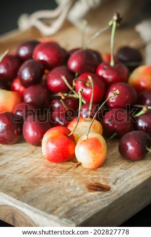 White and red cherries on a rustic background