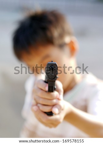Boy play toy gun.