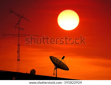 TV antenna , satellite dish silhouette on sunset background.