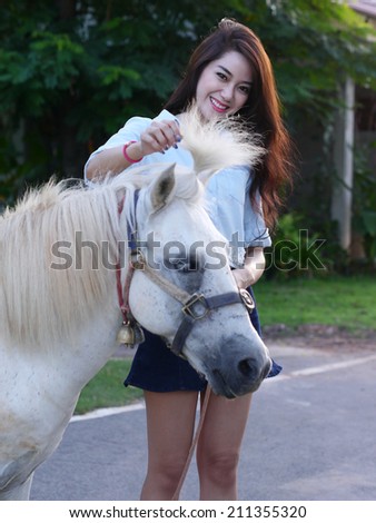 Portrait asian girl and white horse.