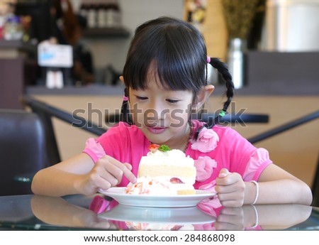 girl eat cake in bakery shop