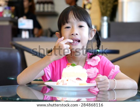 girl eat cake in bakery shop
