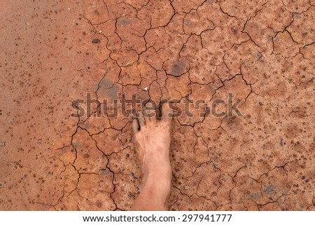 dirty foot on cracked earth