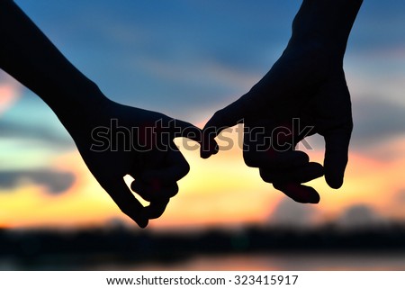 be hand in hand on sunset background