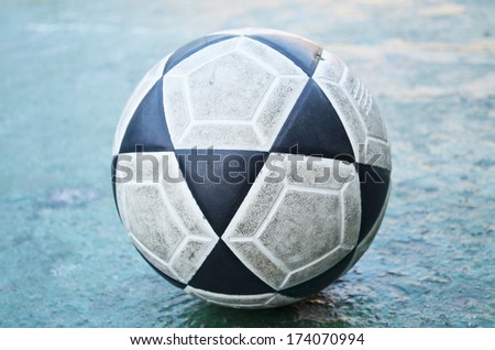 Old football on the ground ready to kick
