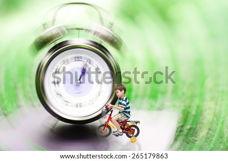 Little boy riding bicycle pass the clock time machine back to the past or future