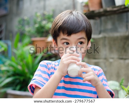 Little boy drinking milk in the park vintage color style