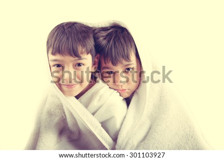 Little sibling boy with towel cover on head