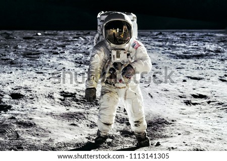 Astronaut on lunar moon landing mission Apollo 11. Astronaut space walk on moon surface in spacesuit. Space,science fiction,galaxy & universe wallpaper. Elements of this image furnished by NASA