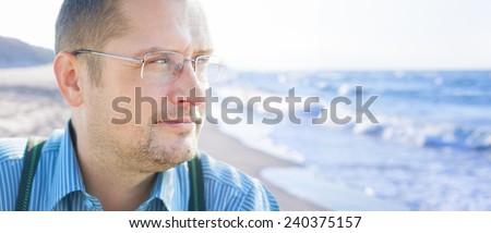 man 45 smiling  outdoor looking sea glasses