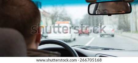 driver eyes car driving steering wheel city road inside view