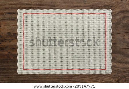 cloth table edge fabric torn, red stitch cross border