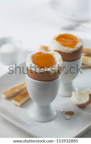 Two brown soft-boiled eggs for breakfast - both opened