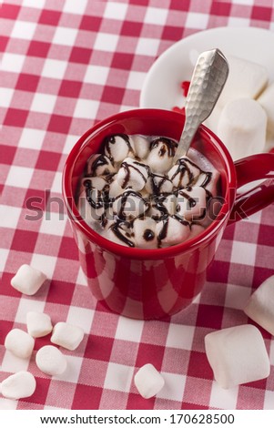 Hot double chocolate and small marshmallows in red cup