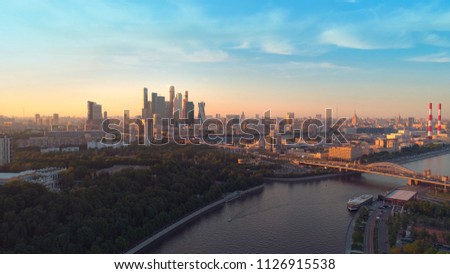 Moscow International Business Center, Moscow-city. A sunset aerial shot of skyscrapers with beautiful evening sky and the Moscow river on the background. Aerial high altitude drone flight.